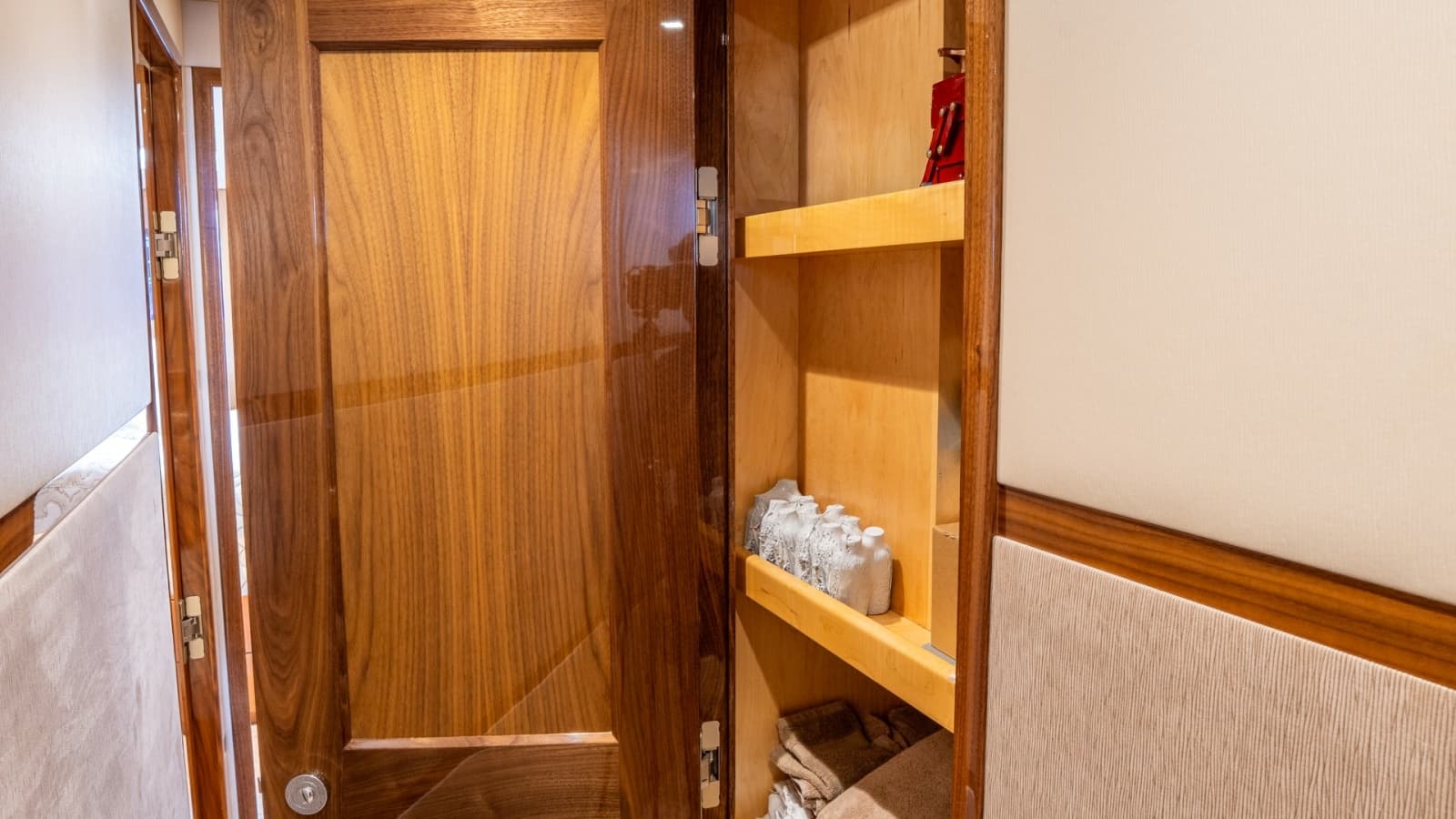 2020 Viking 92 Skybridge "After Midnight" Features A Hallway Linen Storage Area.