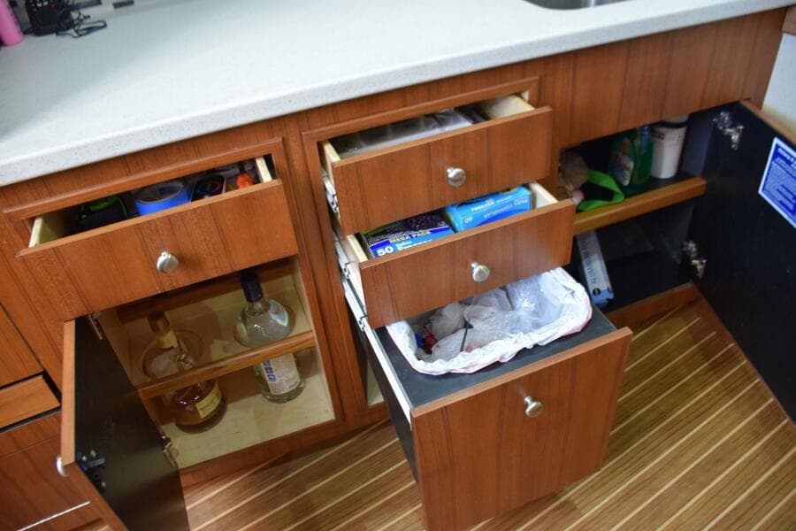Lower cabinets and drawers open - trashcan