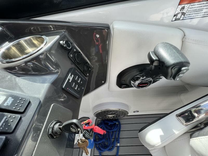 2022 Monterey M-45 boat cockpit with control panel, steering wheel, and ignition keys.