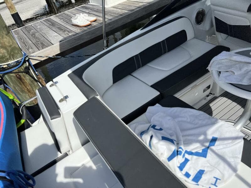 Luxury seating area on a 2022 Monterey M-45 boat docked by a pier.