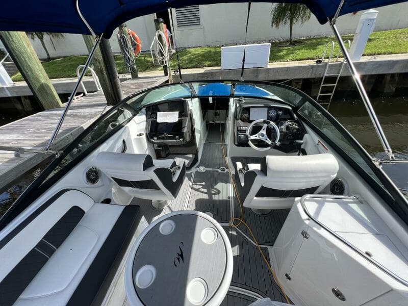 2022 Monterey M-45 boat interior with white seating, steering wheel, and table.