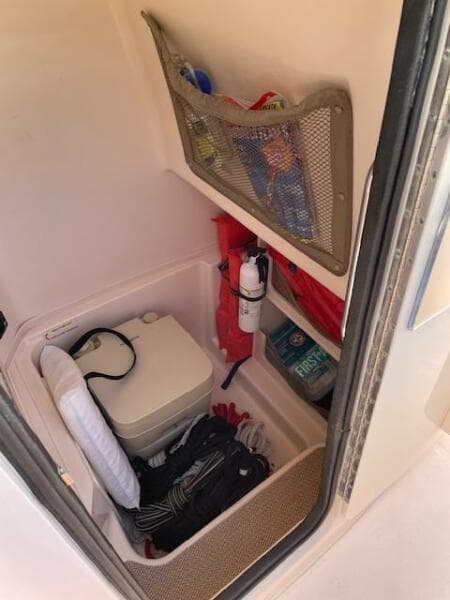 2014 Grady-White Fisherman 257 storage compartment with safety equipment and supplies.