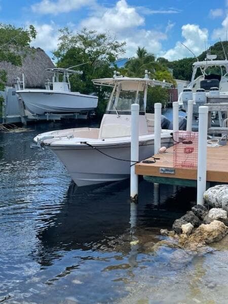 2014 Grady-White Fisherman 257 docked at a marina on a sunny day.