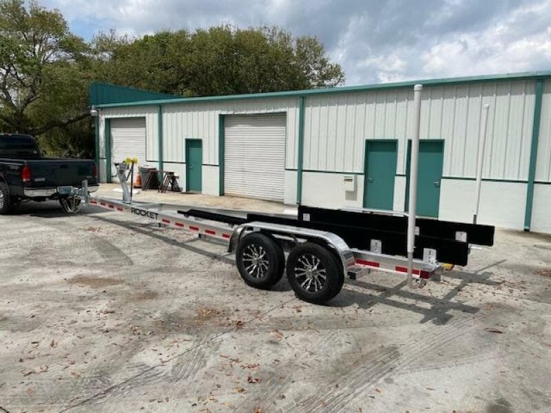 Boat trailer for 2014 Grady-White Fisherman 257 in front of storage units.