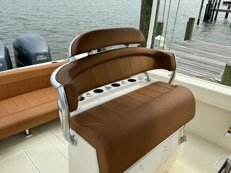 2004 Intrepid 32 Cuddy boat with brown leather seating and twin 250 engines.