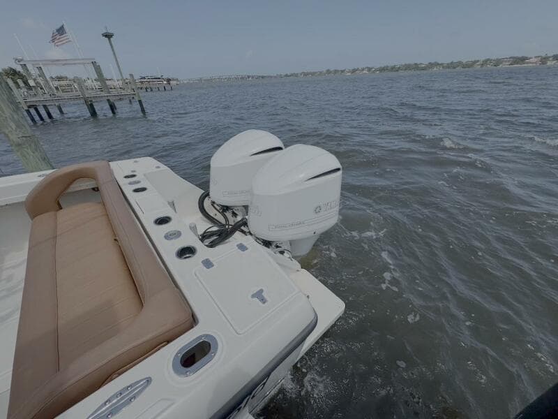 2004 Intrepid 32 Cuddy boat with twin outboard engines on the water.
