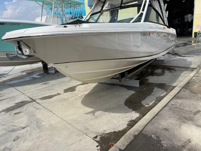 2018 Boston Whaler 270 Vantage boat on a concrete dock, side view.