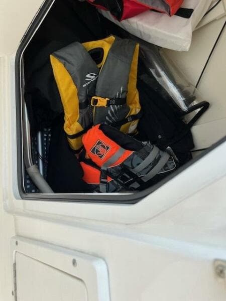 Life jackets stored in a compartment on a 2018 Boston Whaler 270 Vantage boat.