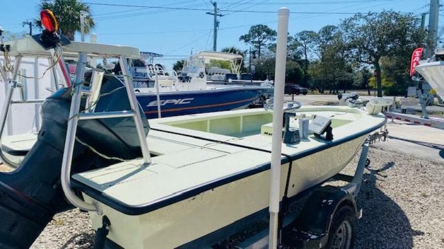 1983 Maverick 18 Flats Boat on a trailer in a boatyard.