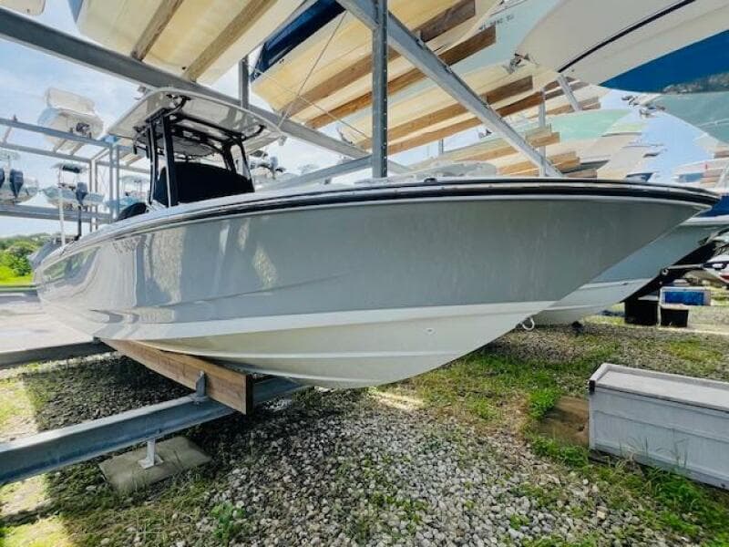 2023 Boston Whaler 250 Dauntless boat on storage rack, side view.