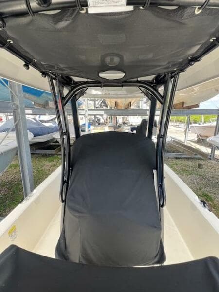 2023 Boston Whaler 250 Dauntless boat interior with covered seating and canopy.