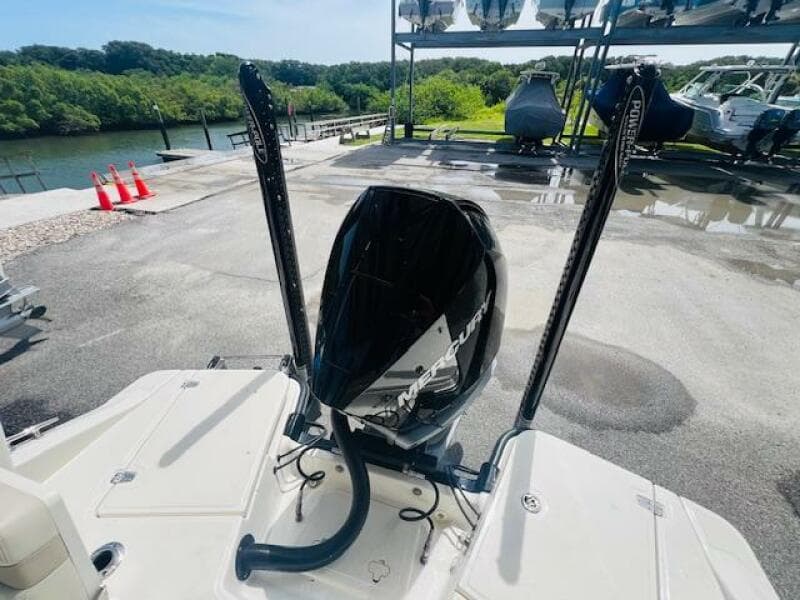2023 Boston Whaler 250 Dauntless boat engine at dockside with scenic background.