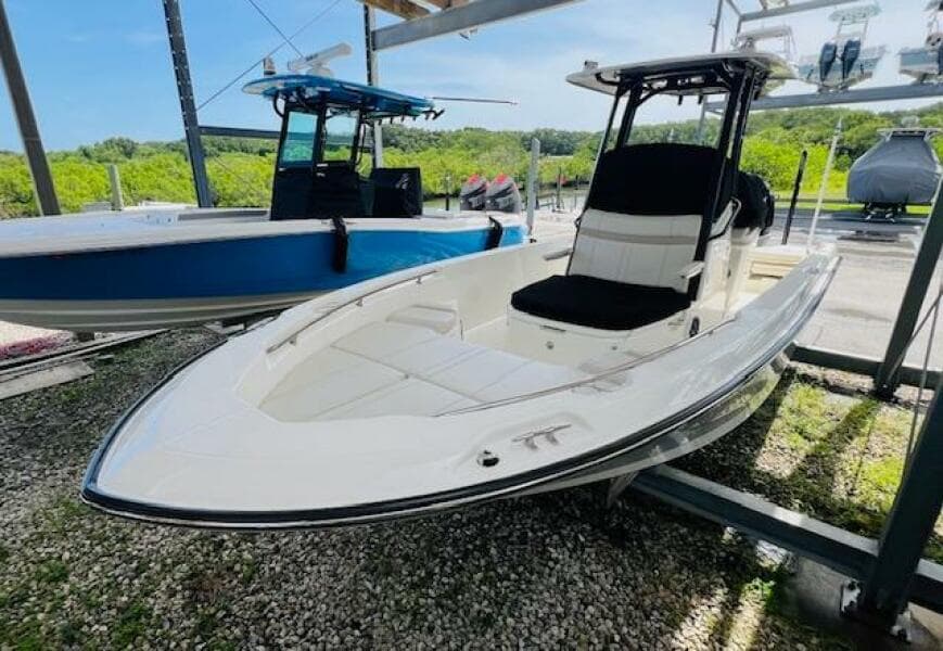 2023 Boston Whaler 250 Dauntless boat displayed outdoors on gravel.