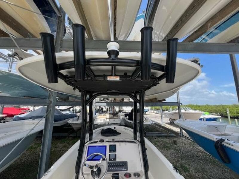 2023 Boston Whaler 250 Dauntless boat in storage, featuring a modern console and T-top.