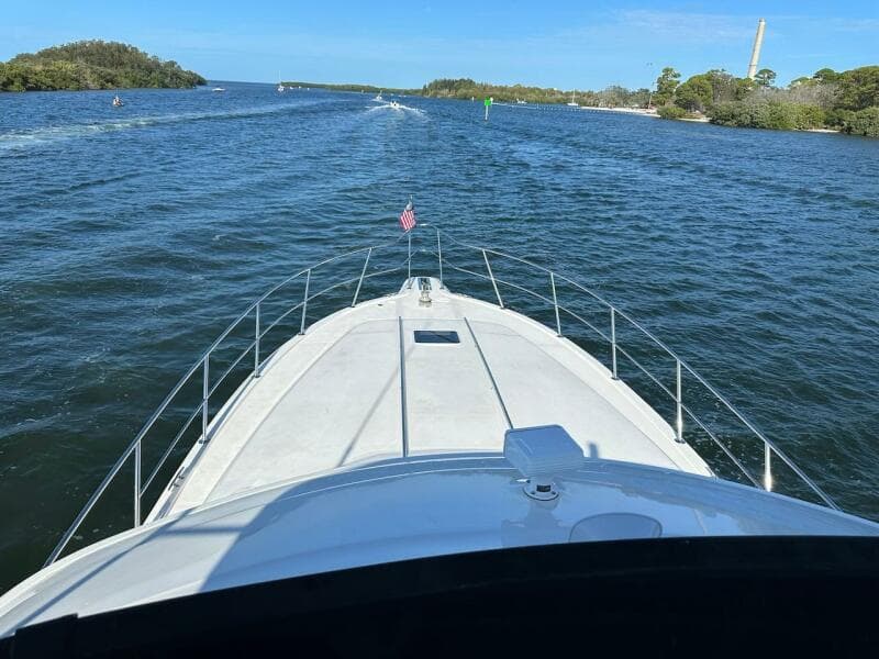 1997 Sea Ray 550 Sedan Bridge cruising on a scenic waterway.