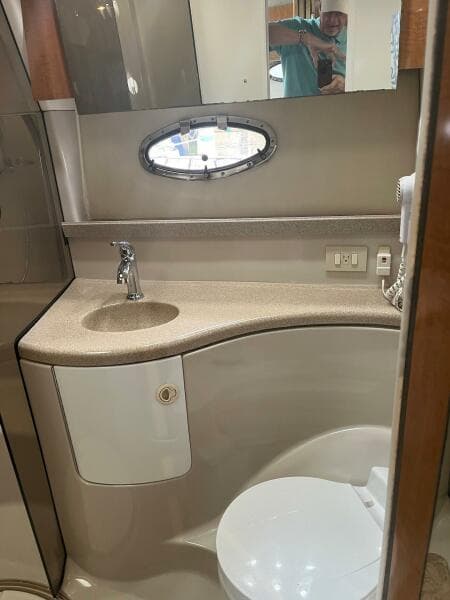 2003 Regal Commodore 3860 bathroom with sink, mirror, and toilet.