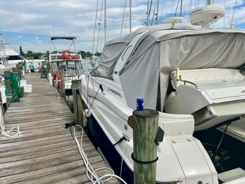 2003 Regal Commodore 3860 yacht docked at a marina with a covered deck.