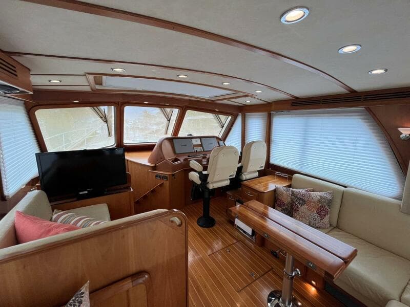 Interior of 2013 Sabre 48 Salon Express yacht with elegant wood finish and modern seating.