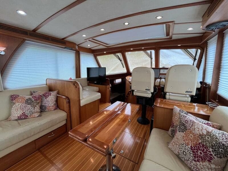 Luxurious interior of 2013 Sabre 48 Salon Express yacht with plush seating and wood finishes.