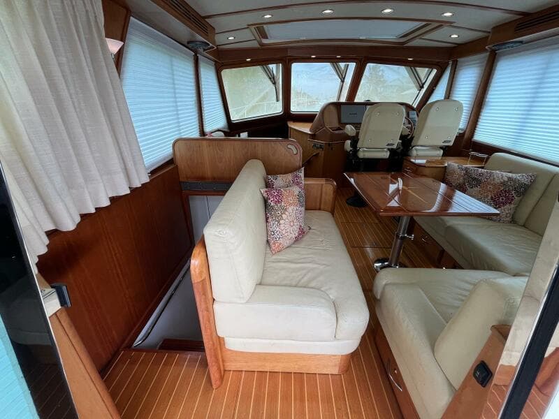 Interior of 2013 Sabre 48 Salon Express yacht with elegant seating and wooden finishes.