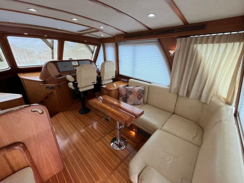 Interior of 2013 Sabre 48 Salon Express with plush seating and wooden accents.