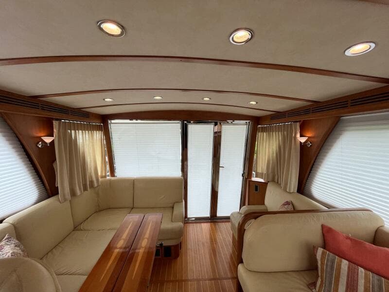 Interior of 2013 Sabre 48 Salon Express yacht with elegant seating and wood accents.