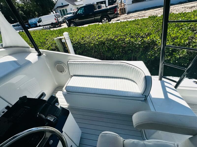 2000 Luhrs Tournament 320 Open boat interior with white seating and steering wheel.