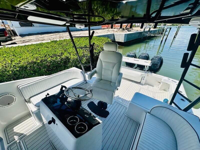2000 Luhrs Tournament 320 Open boat interior with helm, seating, and twin outboard motors.