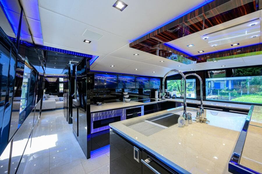 Luxurious kitchen interior of 1997 Broward 108 Raised Pilothouse yacht with modern fixtures.