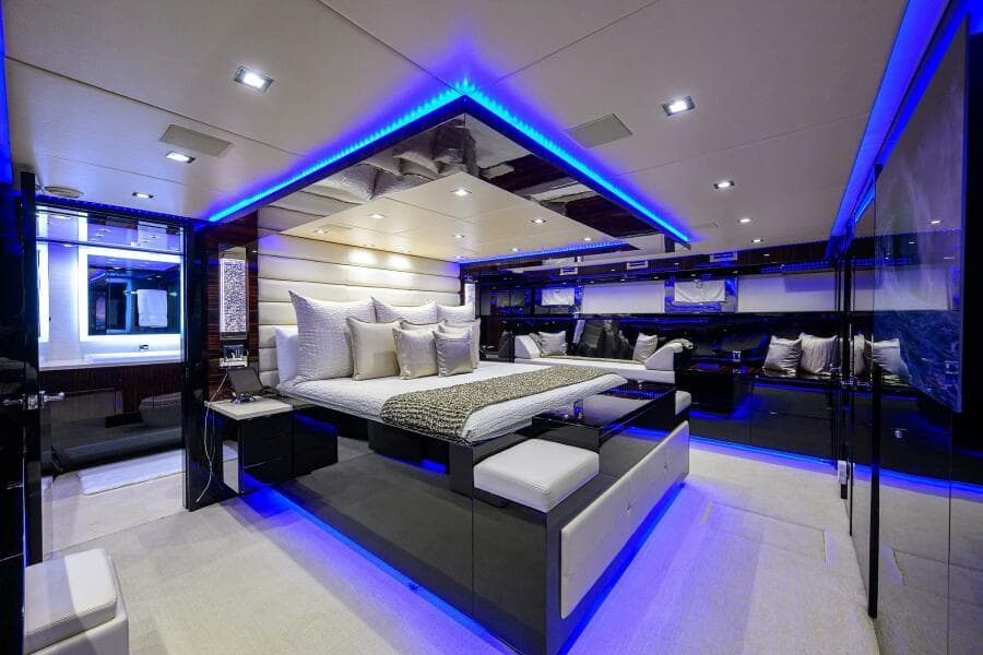 Luxurious master bedroom on a 1997 Broward 108 Raised Pilothouse yacht with modern LED lighting.