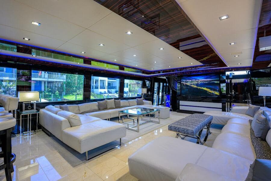 Luxurious interior of 1997 Broward 108 Raised Pilothouse yacht with modern white seating.