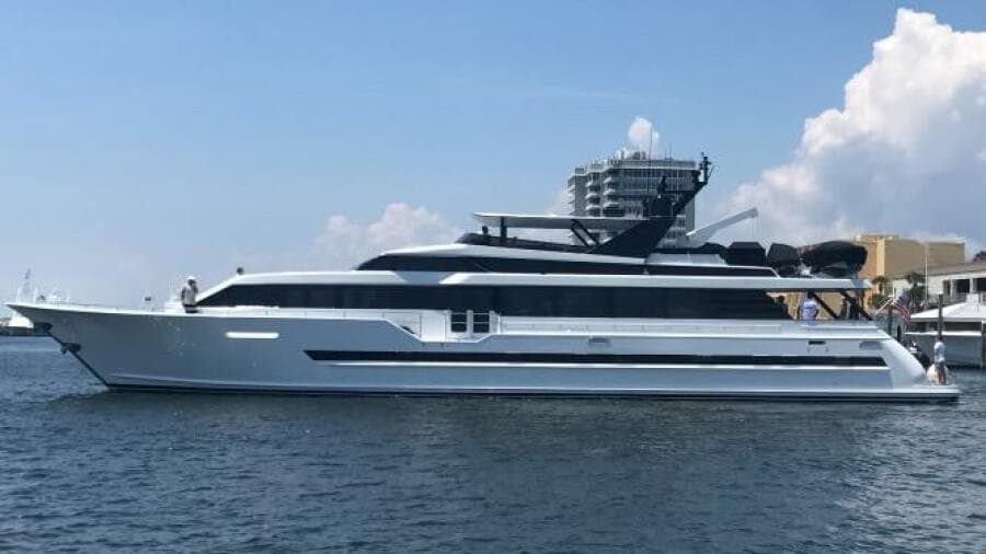 1997 Broward 108 Raised Pilothouse yacht on calm water with clear sky background.