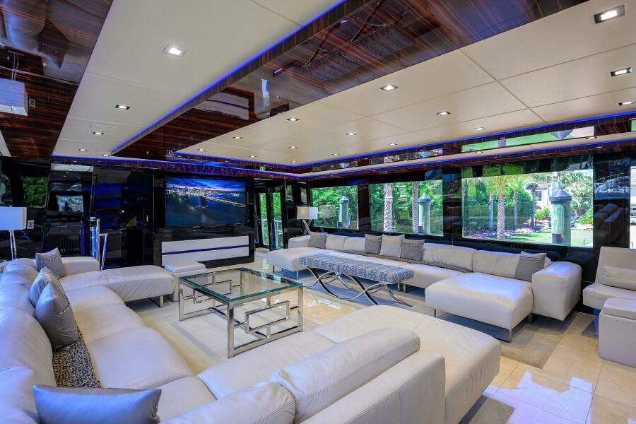 Luxurious interior of 1997 Broward 108 Raised Pilothouse yacht with modern white seating.