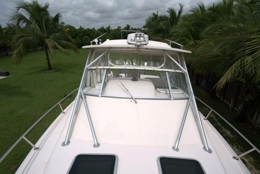 2007 Grady-White Express 330 boat with palm trees in the background.