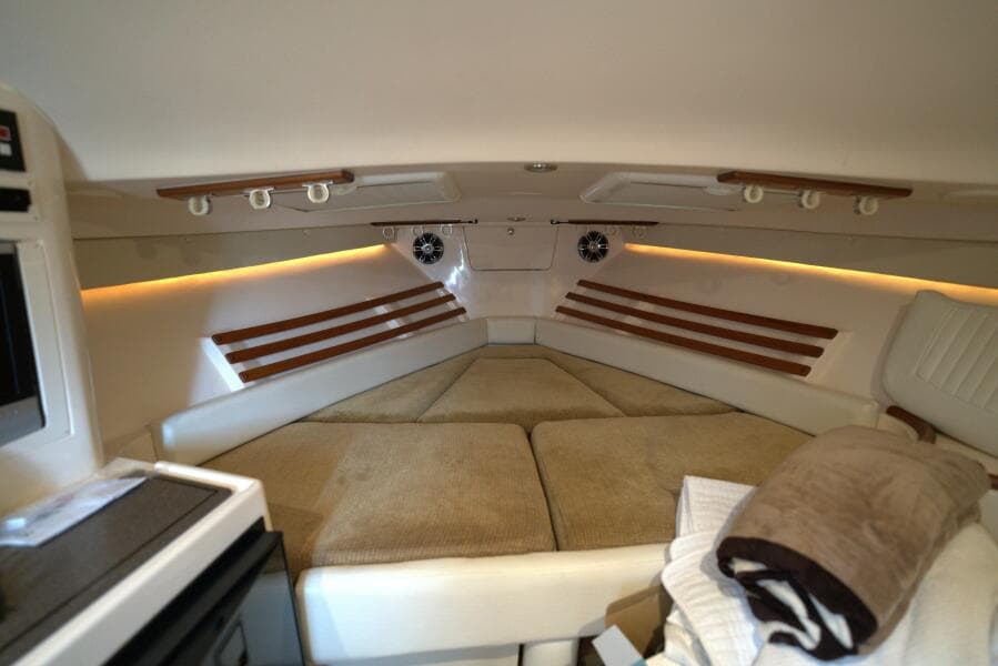 Interior cabin of 2007 Grady-White Express 330 boat with cozy seating and ambient lighting.