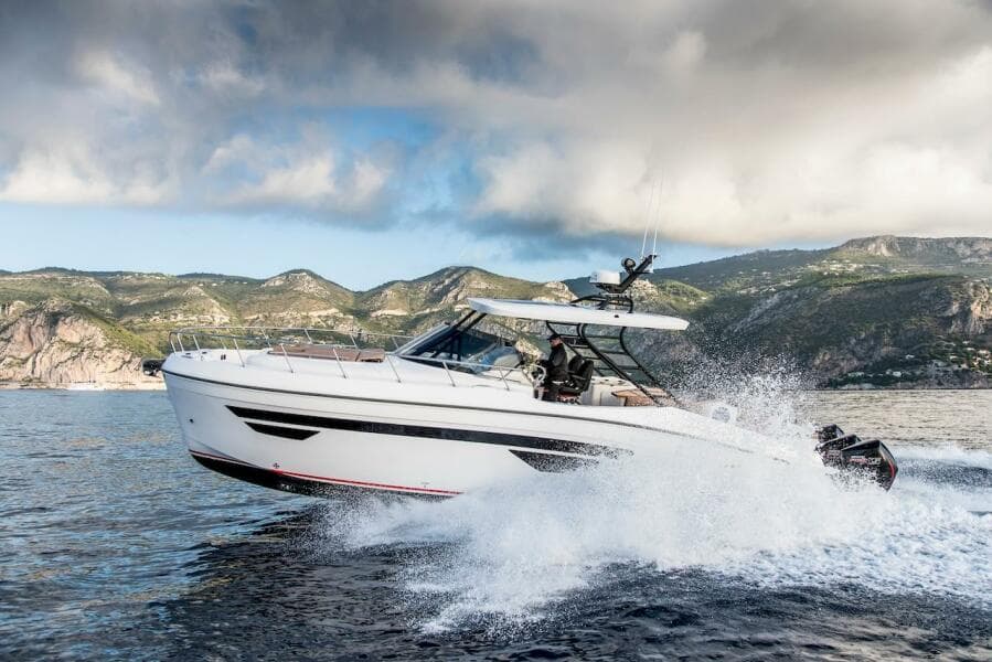 2024 Oryx 379 boat cruising on the water with scenic mountain backdrop.