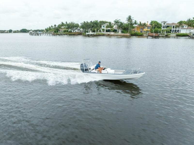 2025 BlueZones Boatworks 16' Flats cruising on a scenic waterway.