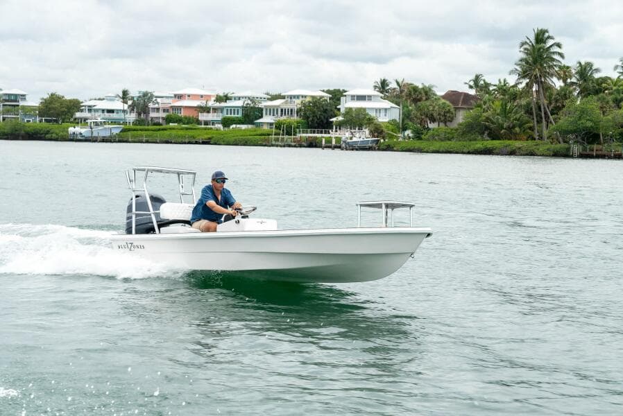 2025 BlueZones Boatworks 16' Flats cruising on a scenic waterway.