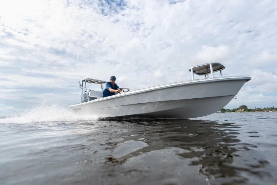2025 BlueZones Boatworks 16' Flats boat cruising on open water.