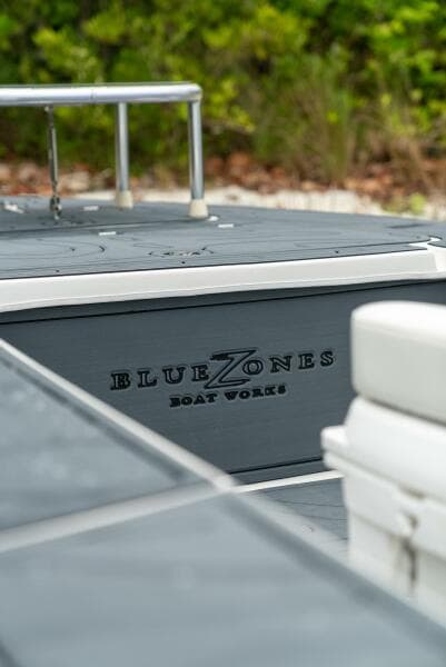 2025 BlueZones Boatworks 16' Flats boat, sleek design, outdoor setting.