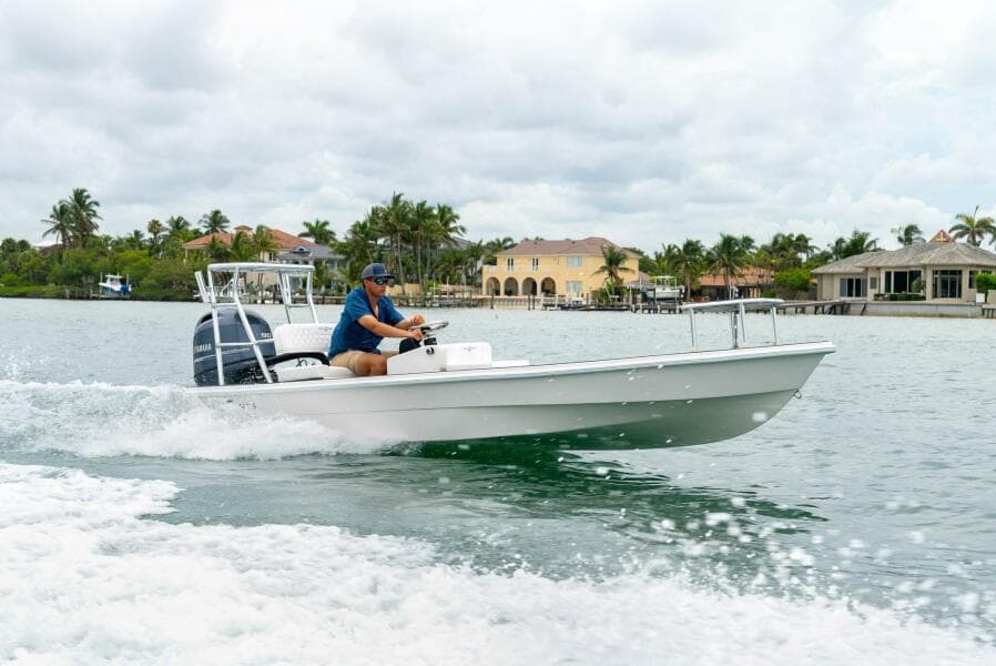 2025 BlueZones Boatworks 16' Flats boat cruising on a scenic waterway.