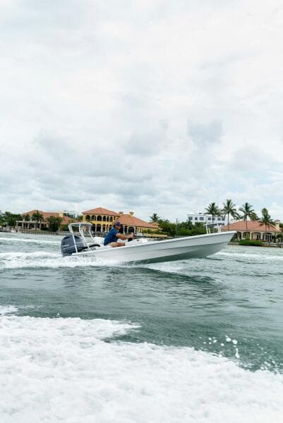 2025 BlueZones Boatworks 16' Flats boat cruising on a scenic waterway.