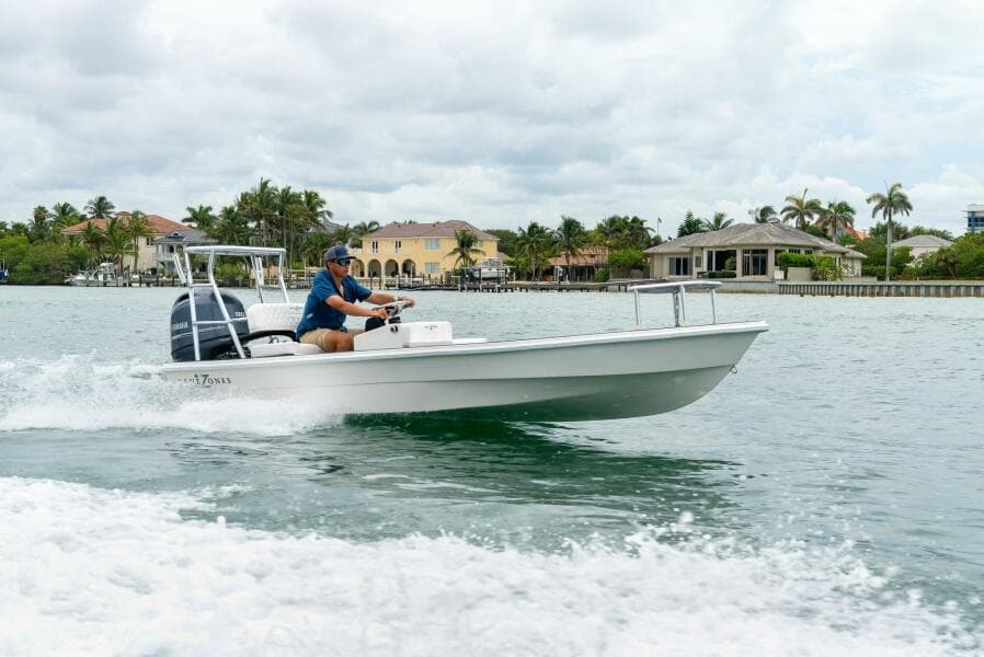 2025 BlueZones Boatworks 16' Flats cruising on a scenic waterway.
