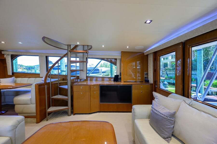 Luxurious interior of 2004 Viking 65 Enclosed Bridge yacht with spiral staircase.