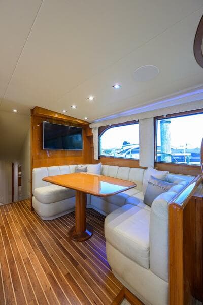 Luxurious interior of 2004 Viking 65 Enclosed Bridge yacht with dining area.