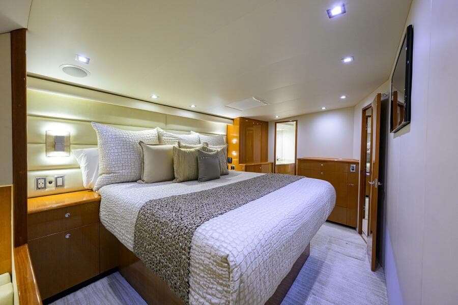 Luxurious bedroom interior of 2004 Viking 65 Enclosed Bridge w/Tower yacht.