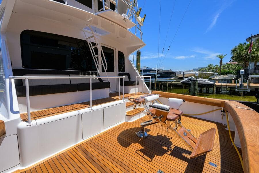 2004 Viking 65 Enclosed Bridge w/Tower yacht deck with fishing chair and seating.