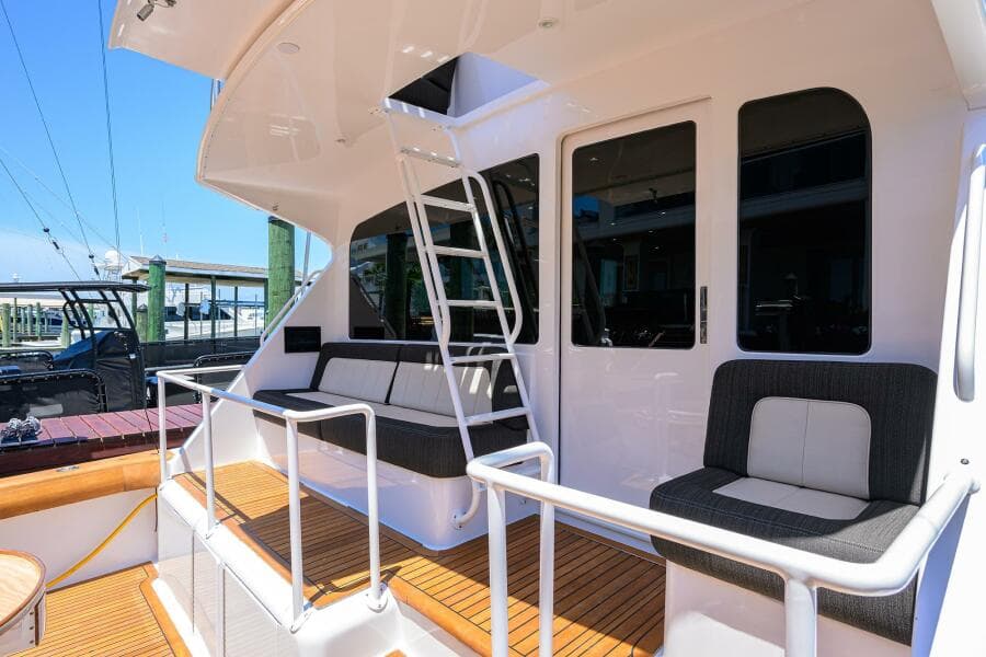 2004 Viking 65 Enclosed Bridge w/Tower yacht deck with seating and ladder.