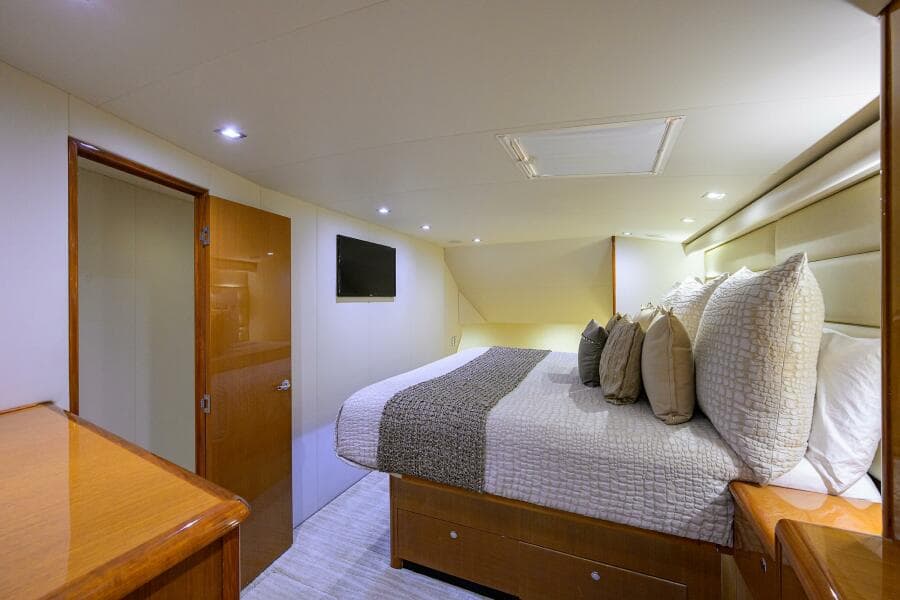 Luxurious bedroom interior of 2004 Viking 65 Enclosed Bridge yacht with modern decor.