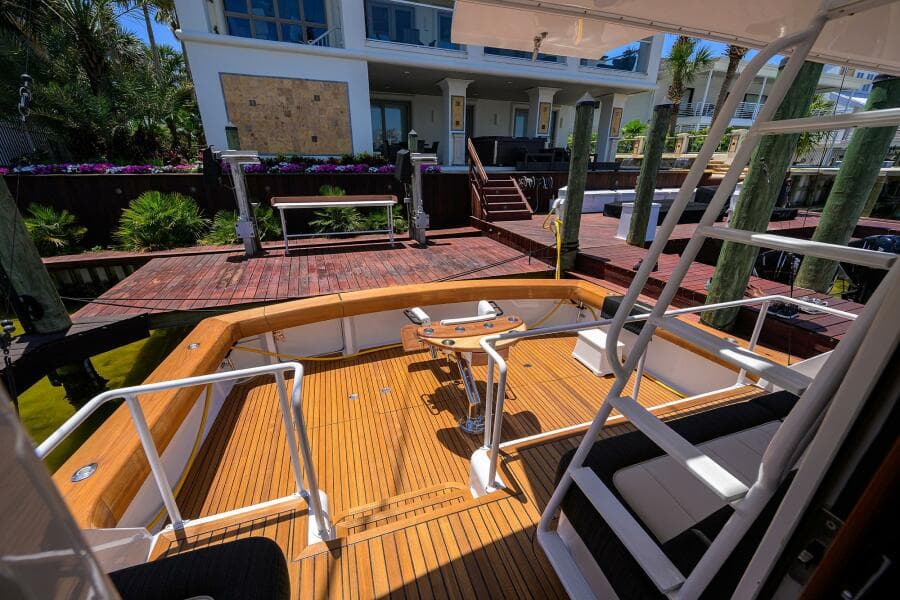 2004 Viking 65 Enclosed Bridge w/Tower yacht docked at a wooden pier.